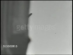 1942: BATTLE OF MIDWAY: VS Imperial Japanese Navy battleships firing anti-aircraft artillery cannons. WS Unidentifiable dive bomber crashing downward. VS Warships firing, explosion at sea, Pacific Ocean. World War II, WWII, Pacific Front Instructional Video