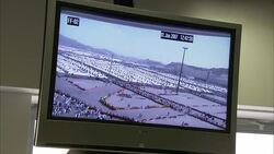 A surveillance monitor in a Saudi Arabian control room displays crowd activity. Stock Footage