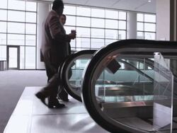  WS Two business associates talking and walking onto a down escalator / Seattle, Washington, United States Stock Footage