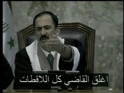 Saddam Hussein ejected from his second trial for genocide. News Clip