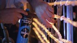 An electrician attaches strings of lights to the Harbor Bridge in Sydney, Australia. Stock Footage