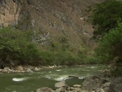 "Pan up from green river rapids and river's edge to green mountain, Utcubamba River [Rio Utcubamba], Peru [PerÃƒÂº]" Stock Footage