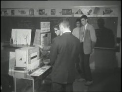 Teenage inventor, Victor Scheinman demonstrates the Electro Mechanical Voice Inscriber at a science fair. News Clip