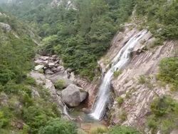 MS AERIAL ZI ZO Shot of waterfall coming down from mountain cliff / Jangheung, Jeollanam do, South Korea Stock Footage