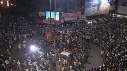 Diwali celebrants carry a litter in a circle as a huge crowd watches. Stock Footage