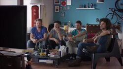 Guys sitting on couch watching tv and cheering Stock Footage