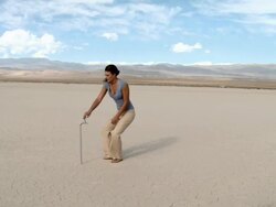 Woman using faucet in desert landscape and finding there is no water Stock Footage