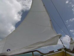 Low Angle hand-held - Wind rustles a sail as it is raised in a sailboat / Great Barrier Reef, Australia Stock Footage