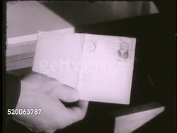 1963: UNITED STATES AIR FORCE ACADEMY: VS Hands putting away hat in closet shelf, personal letter put into drawer. VS Cadet in room deciding where to place patch on bathrobe. Colorado, CO, Rampart Range Instructional Video