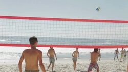 Friends playing beach volleyball Stock Footage