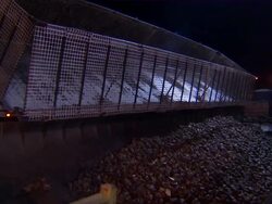 Zoom in to sugar beets falling from trailer into the canal. Stock Footage