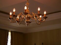 Brass chandelier, Zoom out to show traditional lounge and roaring fire, Lough Erne, Northern Ireland Stock Footage