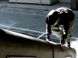 High angle medium shot freerunners jumping onto wall and scaling it Stock Footage