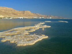WS PAN View of Dead sea salt pans with sky reflection / Ein Bokek, Judea Desert, Israel Stock Footage