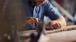 Skilled artisan chisels wood in workshop Stock Footage