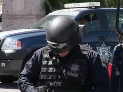 April 9 2009 MS Federal police officer getting dressed, Juarez, Chihuahua, Mexico, AUDIO Stock Footage