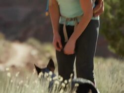 Medium shot of woman hiker playing with dog / Moab, Utah, United States Stock Footage