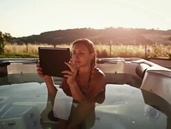 Woman in thermal bath with digital tablet Stock Footage