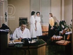 A female student visits a hospital laboratory and watches medical technologists at work, 1954 Stock Footage