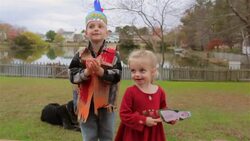 Young boy and young girl perform a Thanksgiving song in backyard Stock Footage
