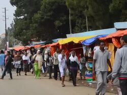 MS Shops along road in downtown with stalls and vendors selling items at Shero Meda area / Addis Ababa, Ethiopia Stock Footage
