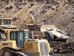 Caterpillar construction vehicles excavating Stock Footage