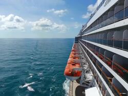 WS Side POV View of Cruise ship Queen Mary 2 of Cunard Line with small boat / North Sea, Jutland, Denmark Stock Footage