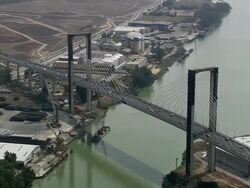 AERIAL WS Warehouses and traffic on V Centenario Bridge / Seville, Andalusia, Spain Stock Footage