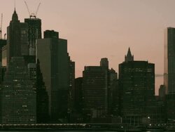 MS PAN DUSK New York Harbor with glass office buildings pan to Brooklyn Bridge/ New York, New York, USA Stock Footage