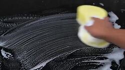 hand of Man washing the car using the yellow sponge with foam Stock Footage