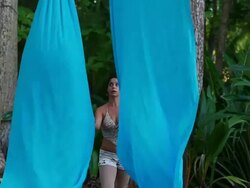 MS Woman twirls fabric around her body and dances with fabric on sandy surface hung from trees in tropical paradise / Montezuma, Puntarenas, Costa Rica Stock Footage