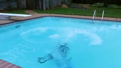 MS TS Man throwing woman in pool during party on summer evening Stock Footage