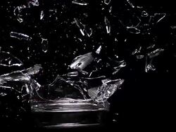 MS SLO MO Glass exploding against black background / Vieux Pont, Normandy, France  Stock Footage