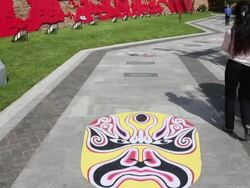 WS PAN Peking Opera and chinese traditional paper cut patterns in park/xian,shaanxi,China Stock Footage