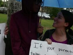 Close-up of protesting couple holding banner and singing  Immigration Activists Protest Outside Of Marco Rubio Fundraiser at Biltmore Hotel on April 05, 2013 in Miami, Florida (Footage by Getty Images)Immigration Activists Protest Outside Of Marco Rubio Fu Stock Footage