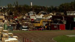A backhoe clears debris from tornado damage. Stock Footage