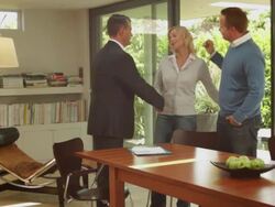 Wide shot off couple handshake with sales person in contemporary home Stock Footage