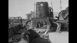 Train engines bound for the USSR from the US as part of Lend-Lease are unloaded onto dock in Iranian port News Clip