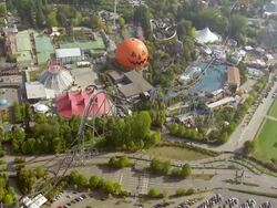 WS AERIAL DS View over roller coaster ride and pumpkin gnomes with parking area in largest theme park / Rust, Baden Wurttemberg, Germany Stock Footage