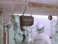 open cans with olives on conveyor belt roll into vintage can closing machines from the 1900s as lids are applied to seal cans  / Ontario, California, USA  Stock Footage