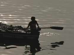 WS Silhouette of man rowing boat in Ganges river / Varanasi, India Stock Footage