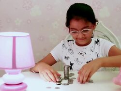 MS PAN Girls making stack of coins / India Stock Footage