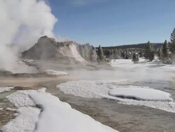 MS TU Geyser erupting in snowy landscape / Yellowstone National Park, Wyoming, United  Stock Footage