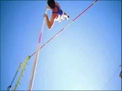 MS athlete Pole Vaulting, clears bar, low angle view, Australia Stock Footage