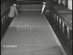 1917: WWI WAR INDUSTRY:  Men rolling out yards of cloth for making uniforms. Men cutting layers of cloth in one pattern. Men at table checking shoe construction. Instructional Video