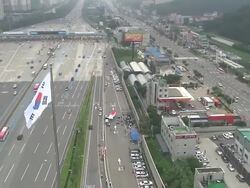 AERIAL View of the traffic nearby Seoul tollgate and Taegeukgi(National flag of Korea) Stock Footage