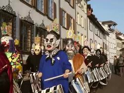 WS Shot of people with mask and dressing up playing drums celebrating Basler Fasnacht (Basel Carnival) on street / Basel, Switzerland Stock Footage