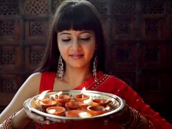 MS Young woman holding  tray of small oil lamps and smiling / Singapore Stock Footage