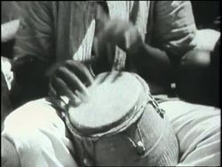 Africans in native dress dance at a ceremony. News Clip