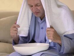 Man with a cold inhaling steam Stock Footage